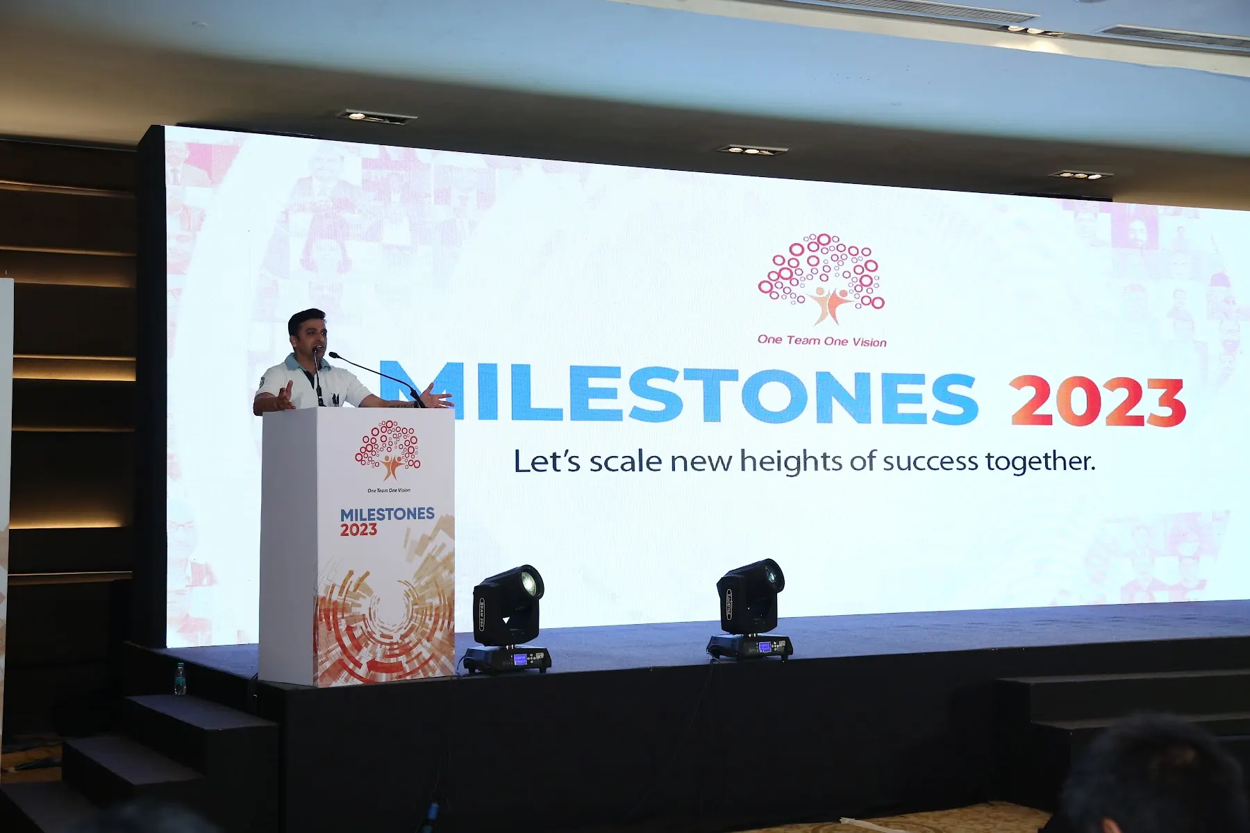 Speaker on stage at the Milestones 2023 corporate event