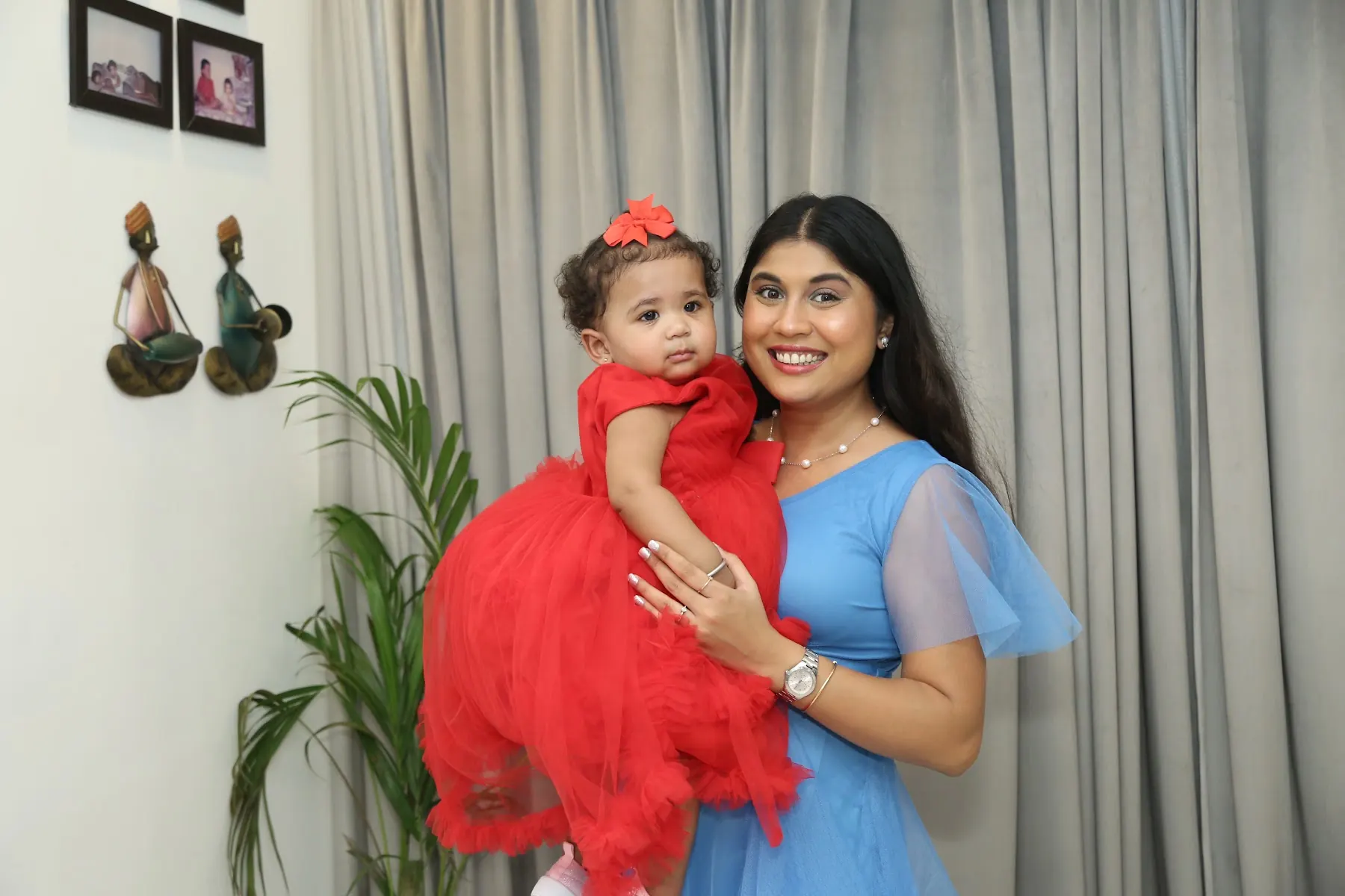 Mother holding her baby at a birthday shoot