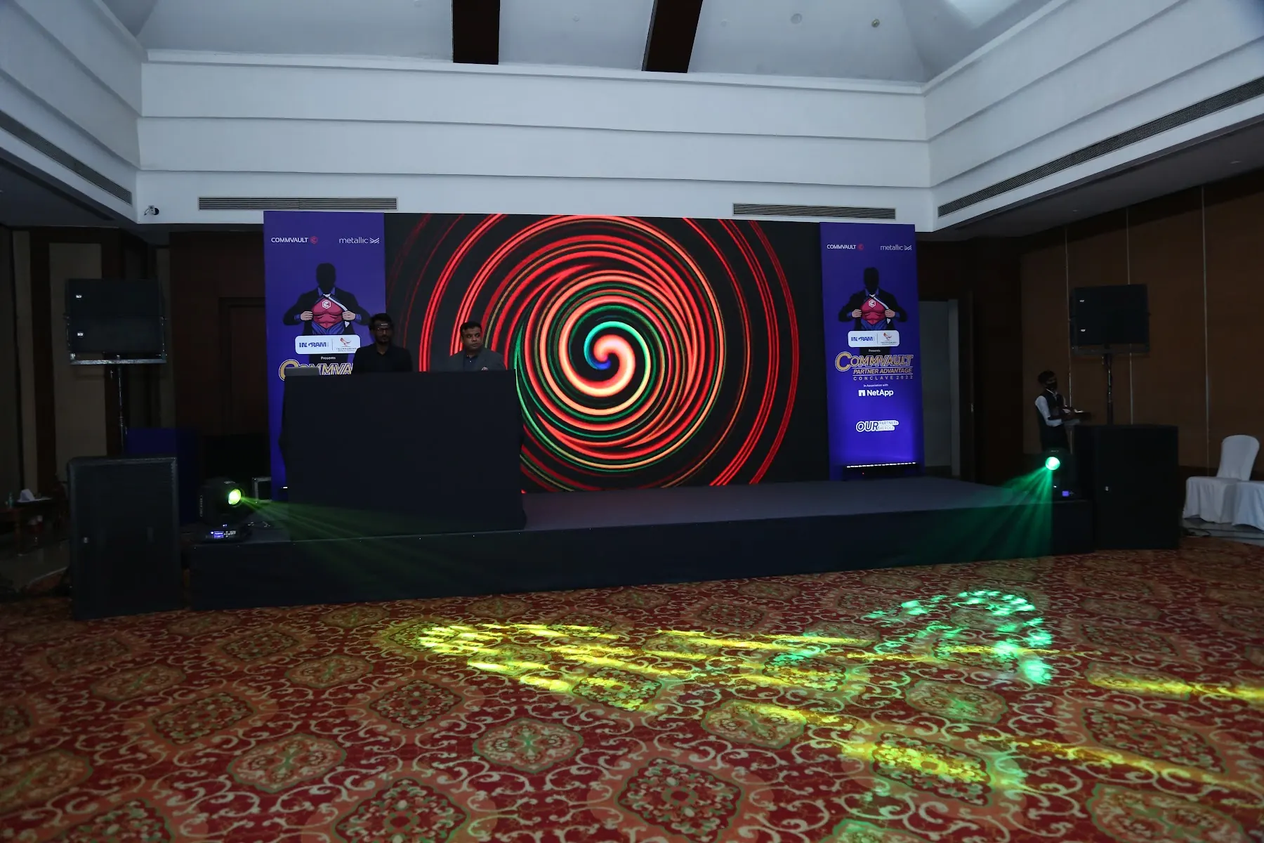 Stage with spiral LED visuals at a partner summit